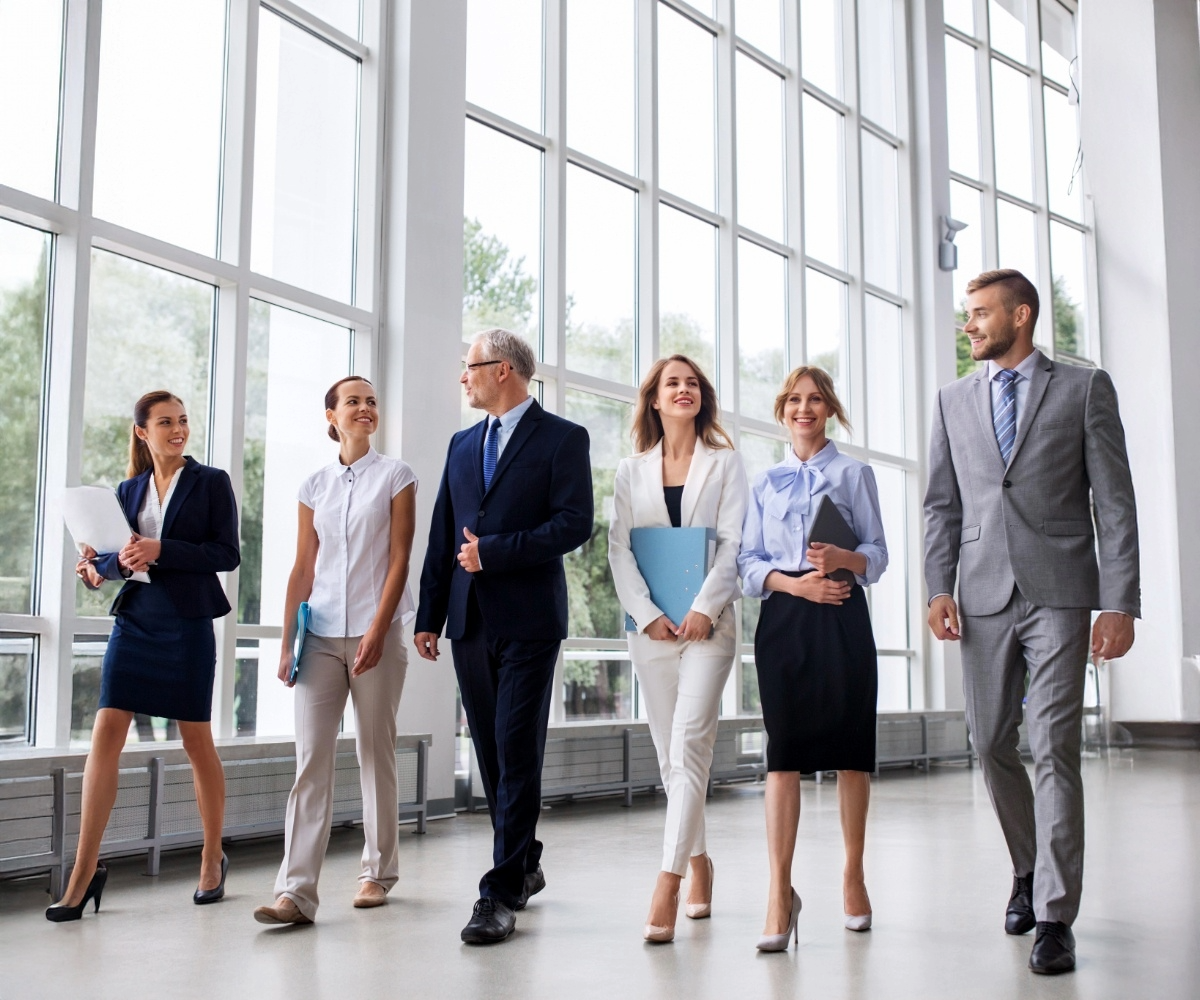 Leadership team walking together in a bright office