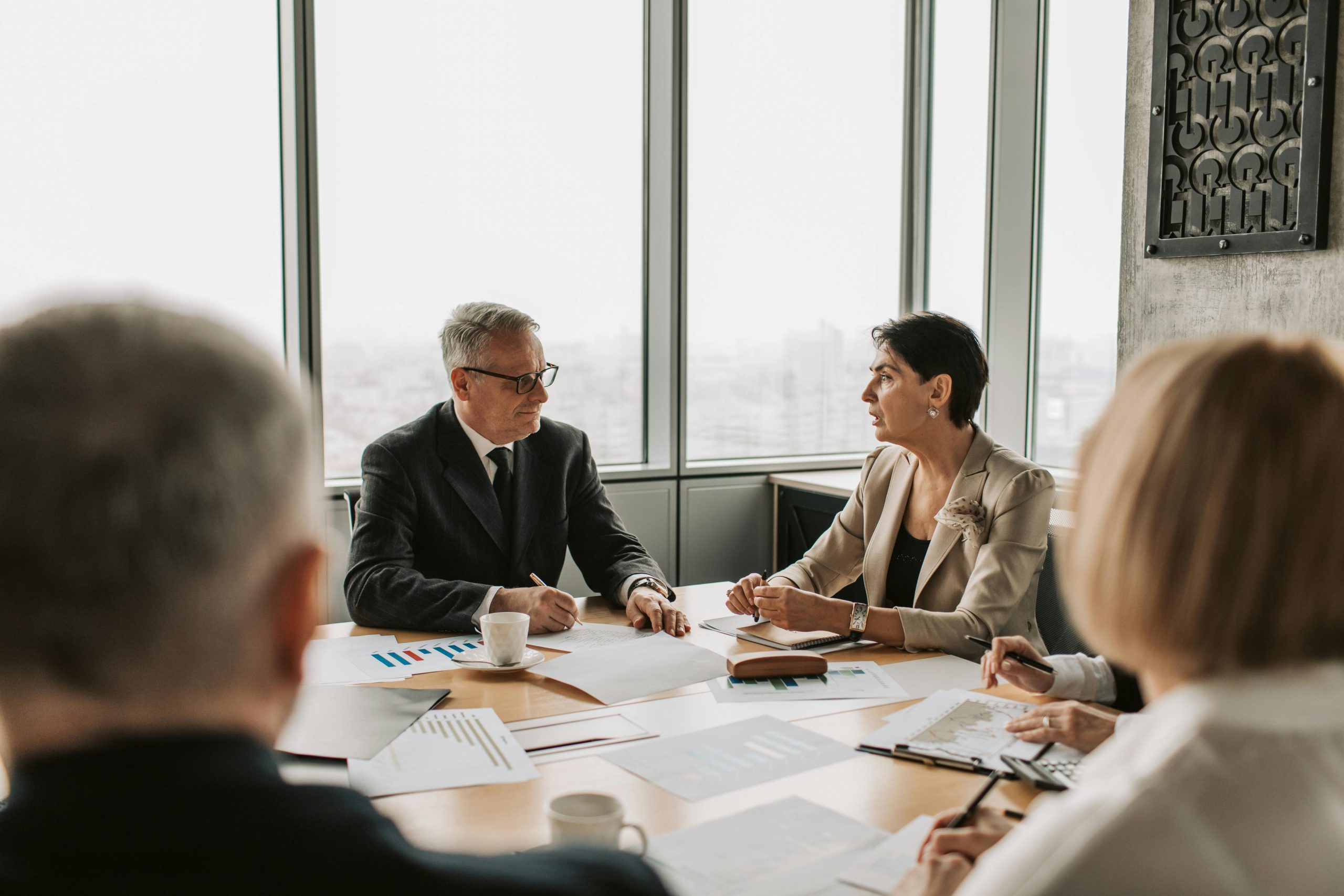 Executives in discussion around a meeting table