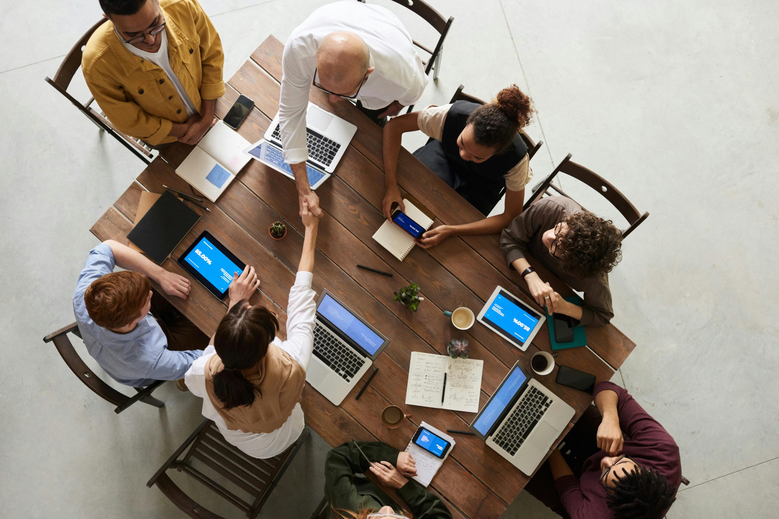 Team working together around a table, seen from above