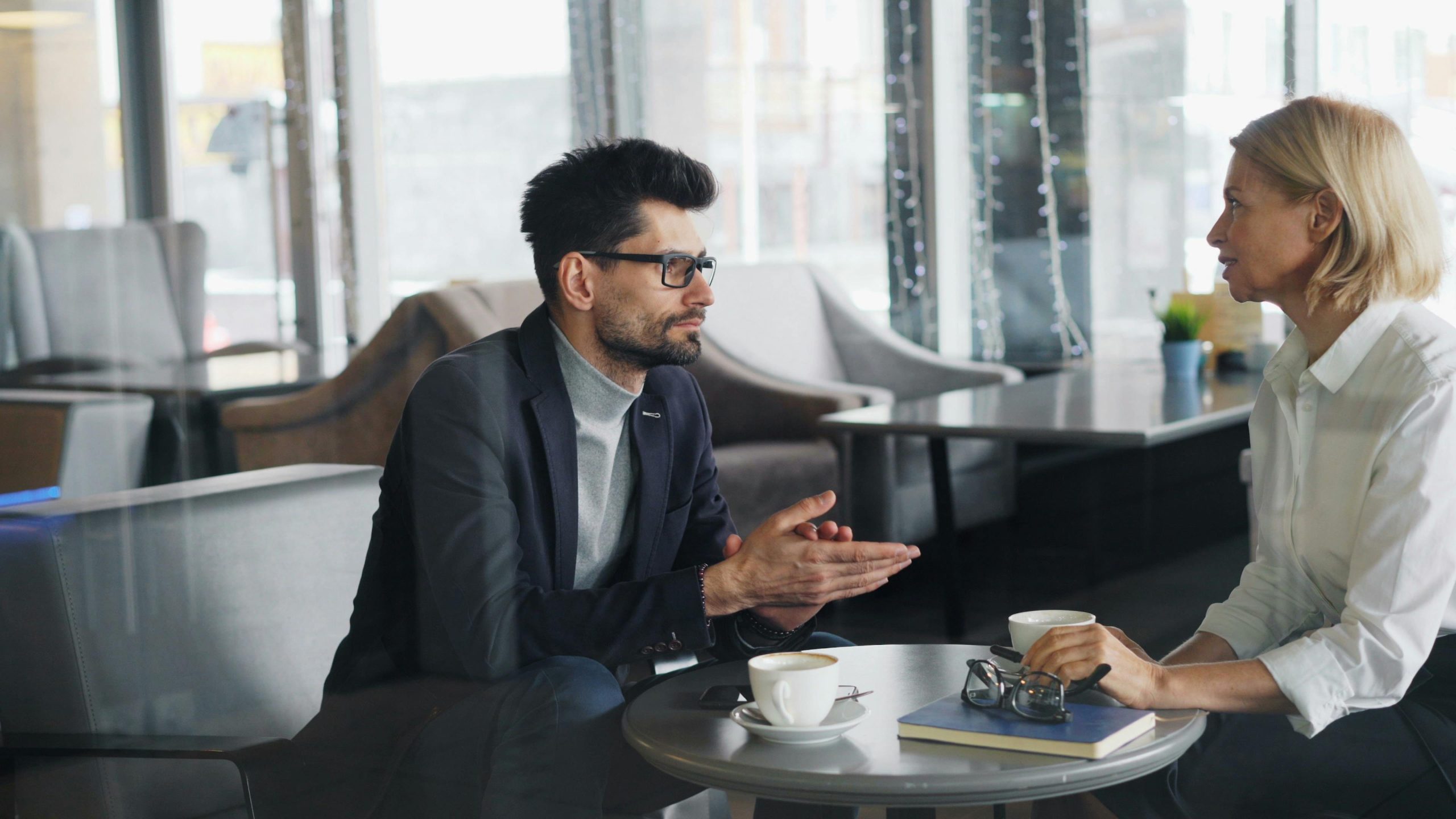 Two colleagues in conversation over coffee