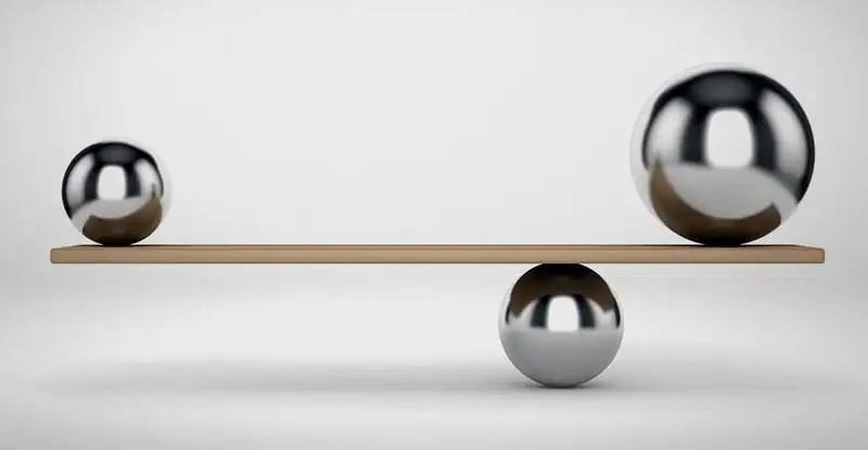 Three steel spheres balanced on a plank