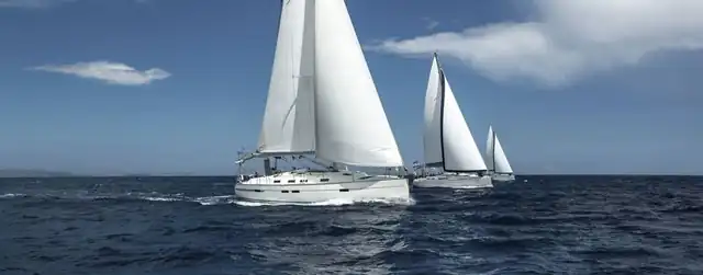 Three sailboats under way on open water